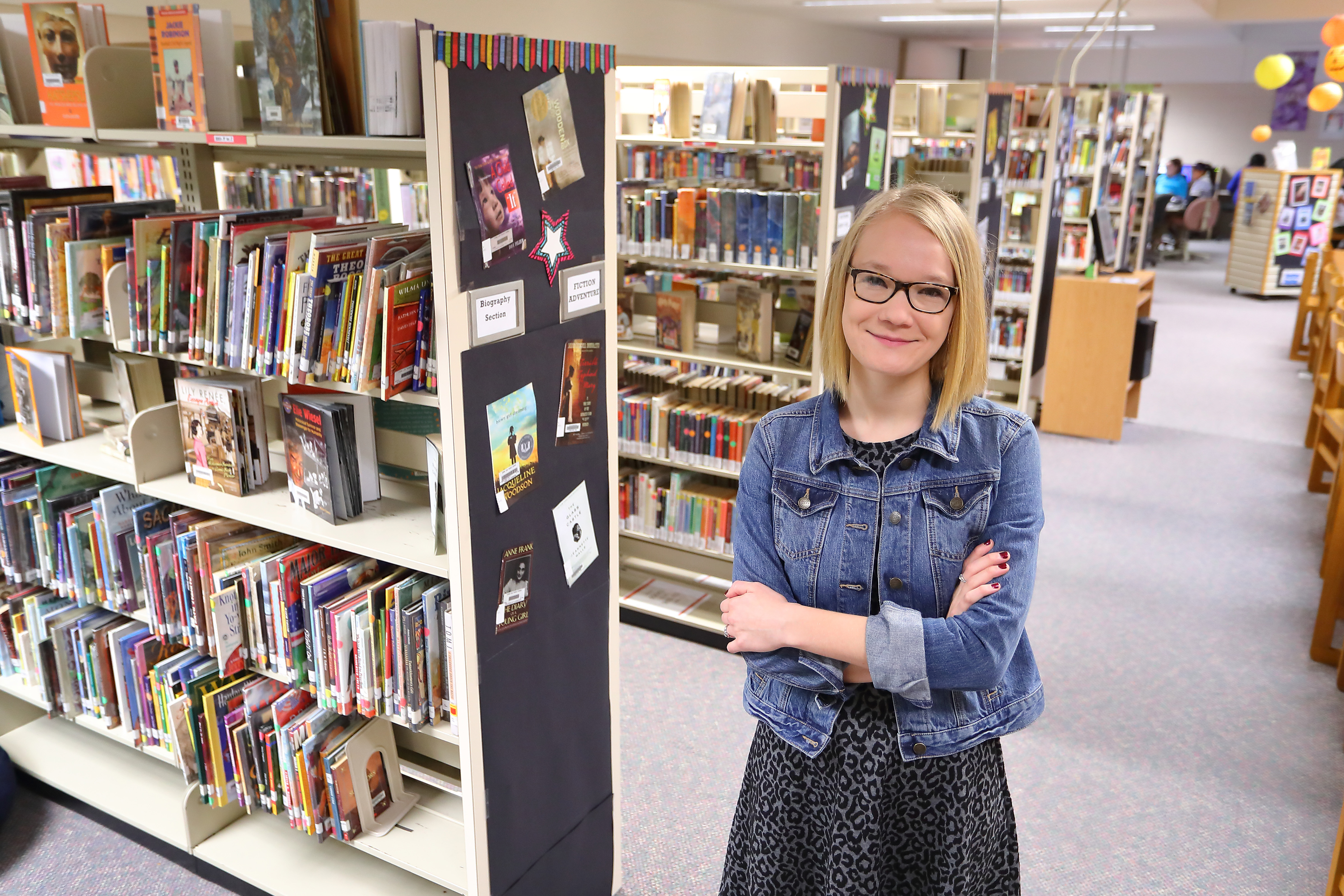 Program graduate Joanna Freking smiling inside her school library